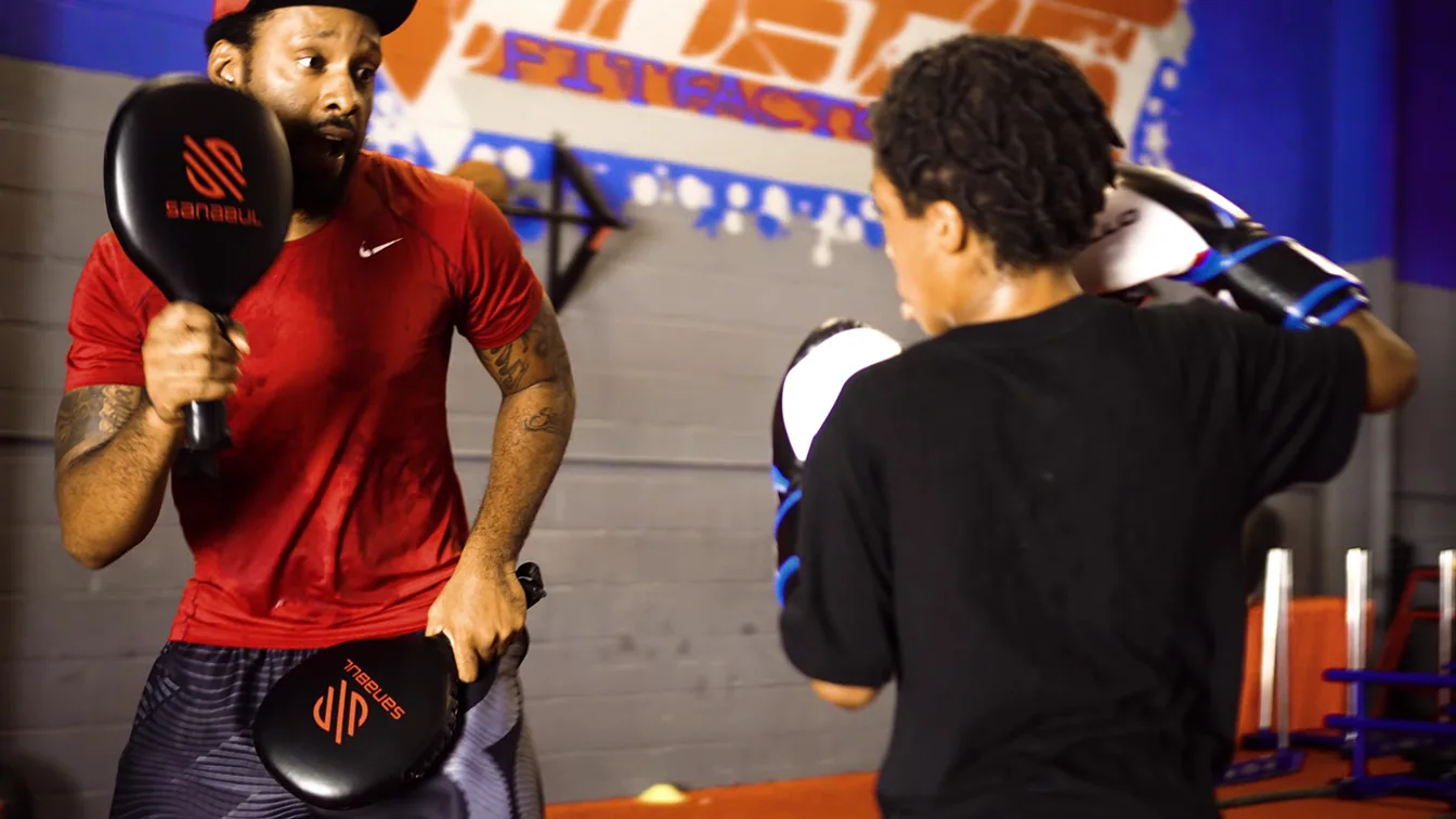 Mike Starr training a young boxer in Atlanta