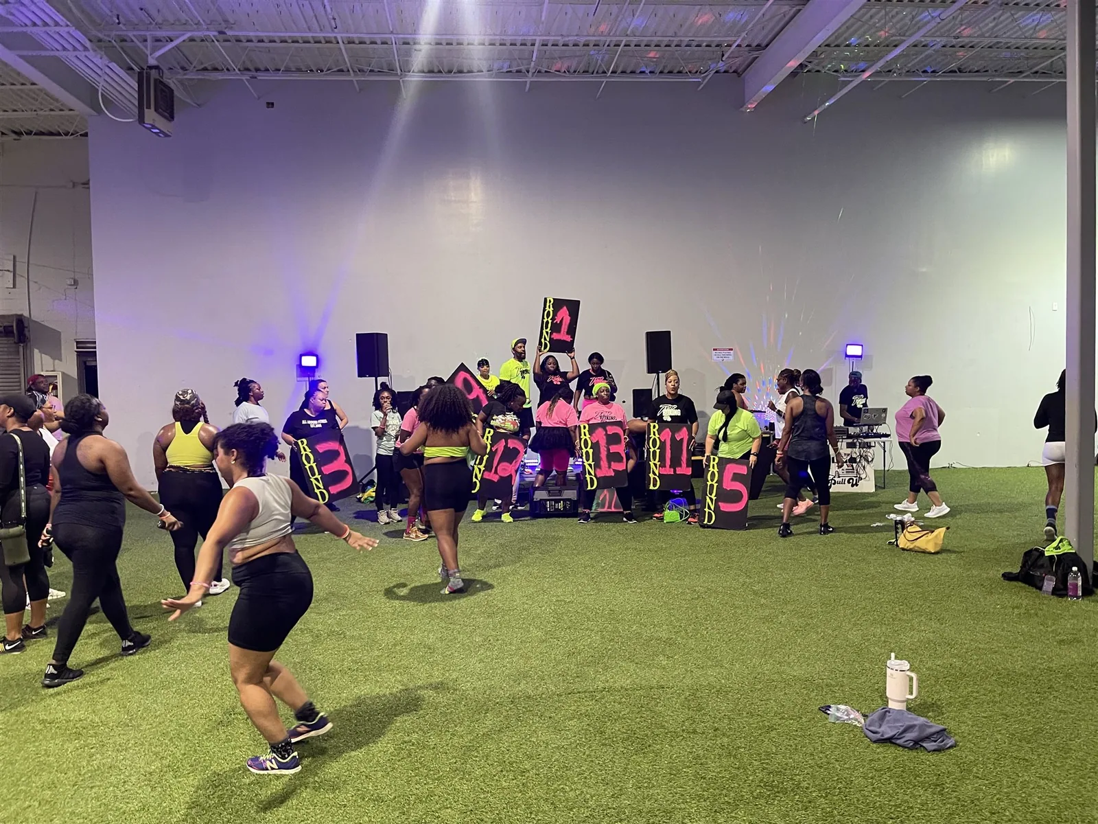 Trap Boxing Atlanta group holding round number signs